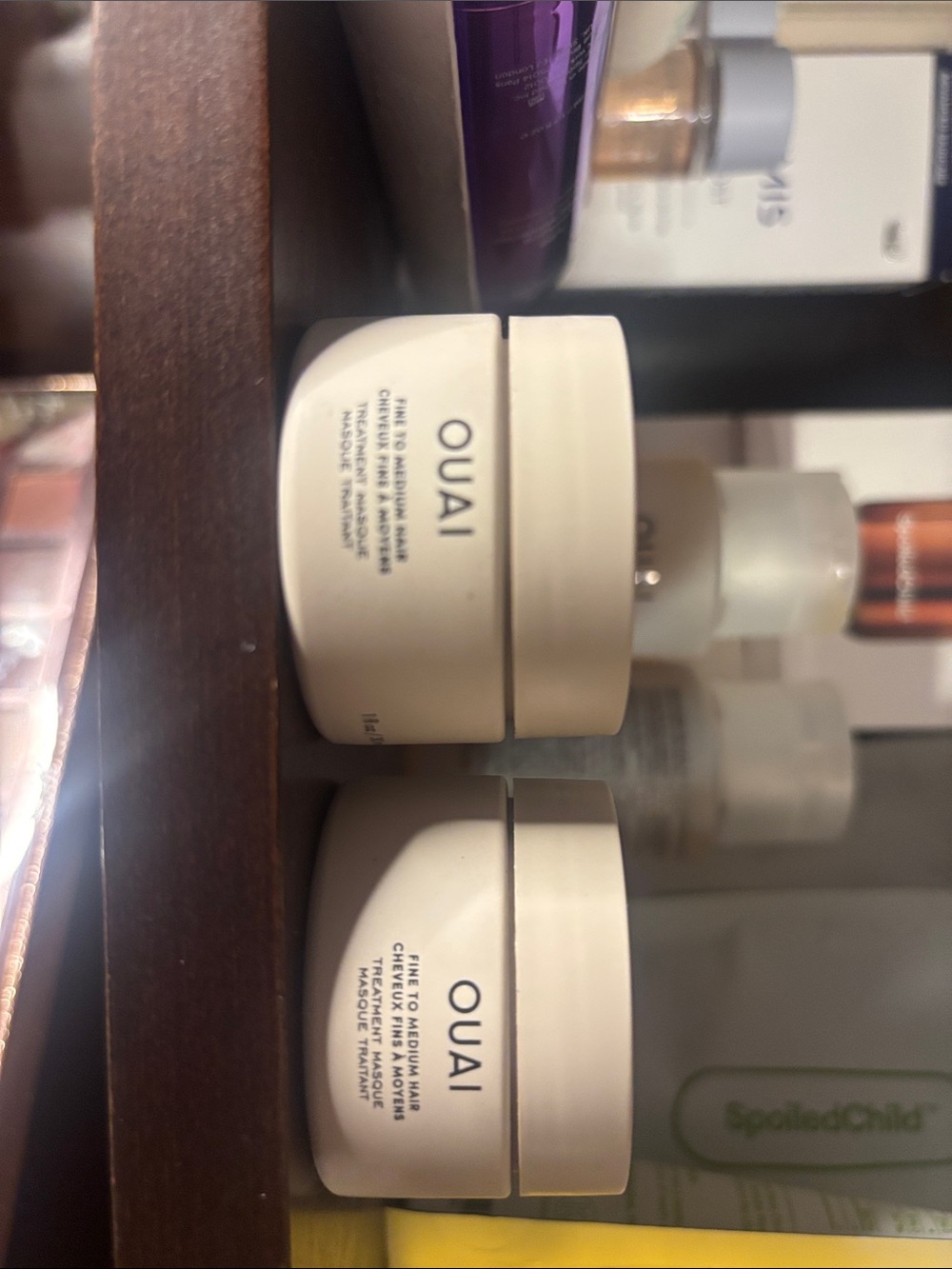 OUAI cream moisturizer jars in off-white